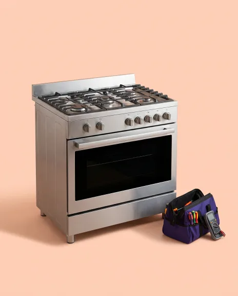 Freestanding range with a glass cooktop and a technician tool bag beside it