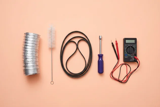 Dryer repair parts and tools on a peach background