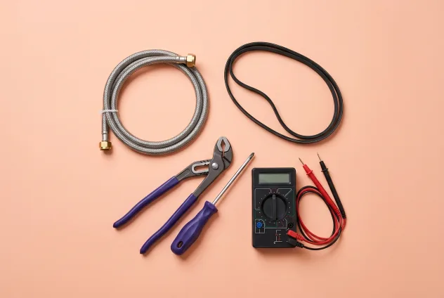 Washer repair parts and tools on a peach background